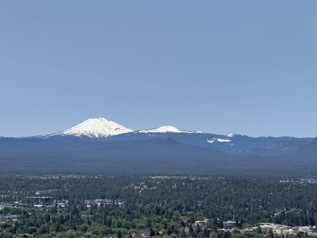 Mount Bachelor's snowcap close above the treeline, downtown Bend below