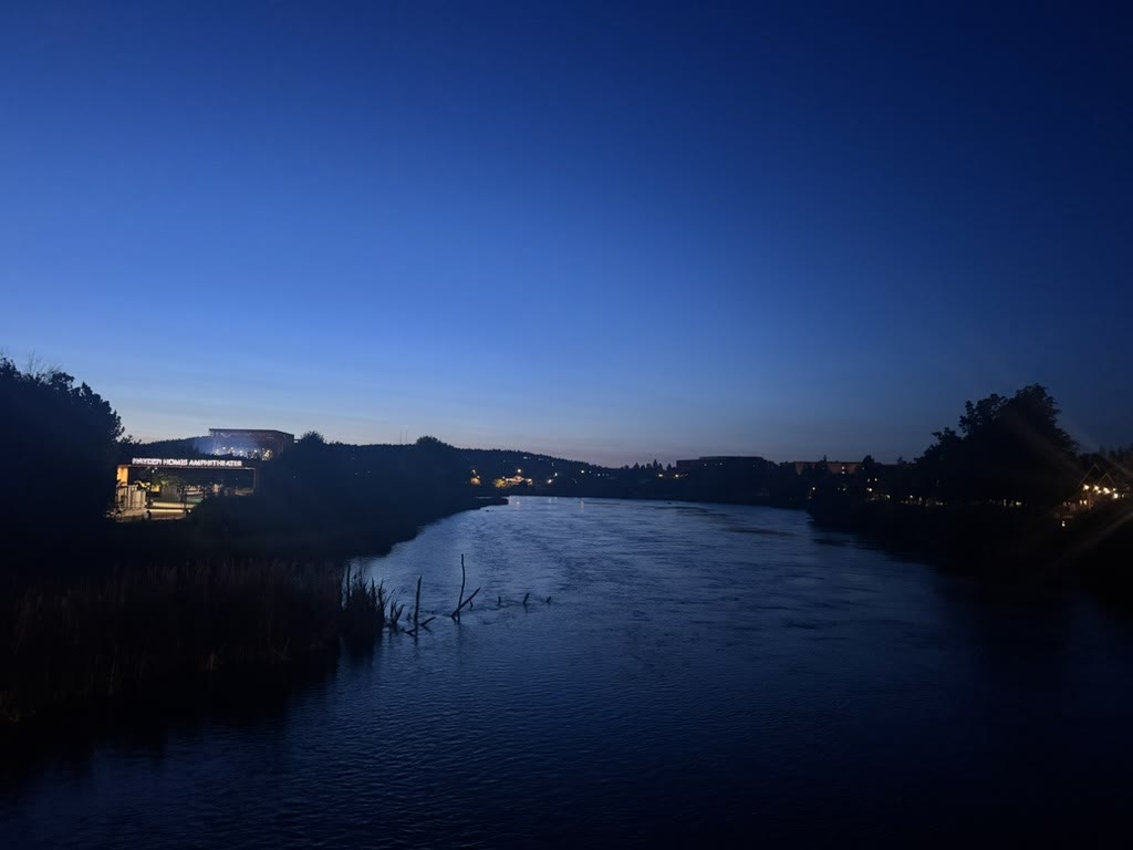 Hayden Homes Amphitheater lit up at dusk along the Deschutes