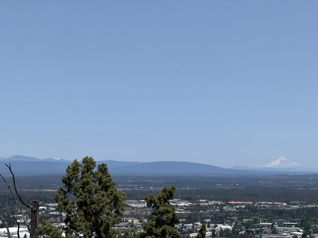 Mount Hood as a tiny pale snowcap on the far horizon, north of Bend