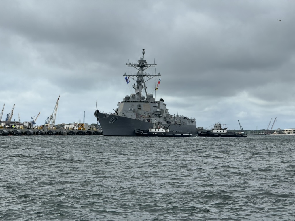 Closer broadside of USS Halsey with two tugs alongside, the destroyer's number 97 visible on her bow