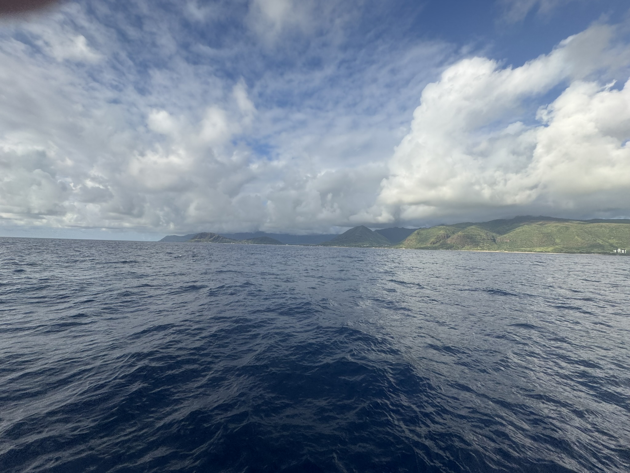 Open ocean from the boat with the Oahu coastline in the distance
