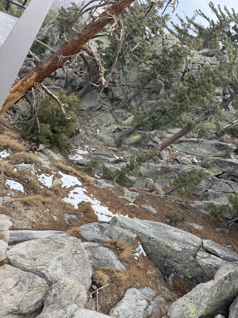 Patches of snow on a rocky slope near the peak