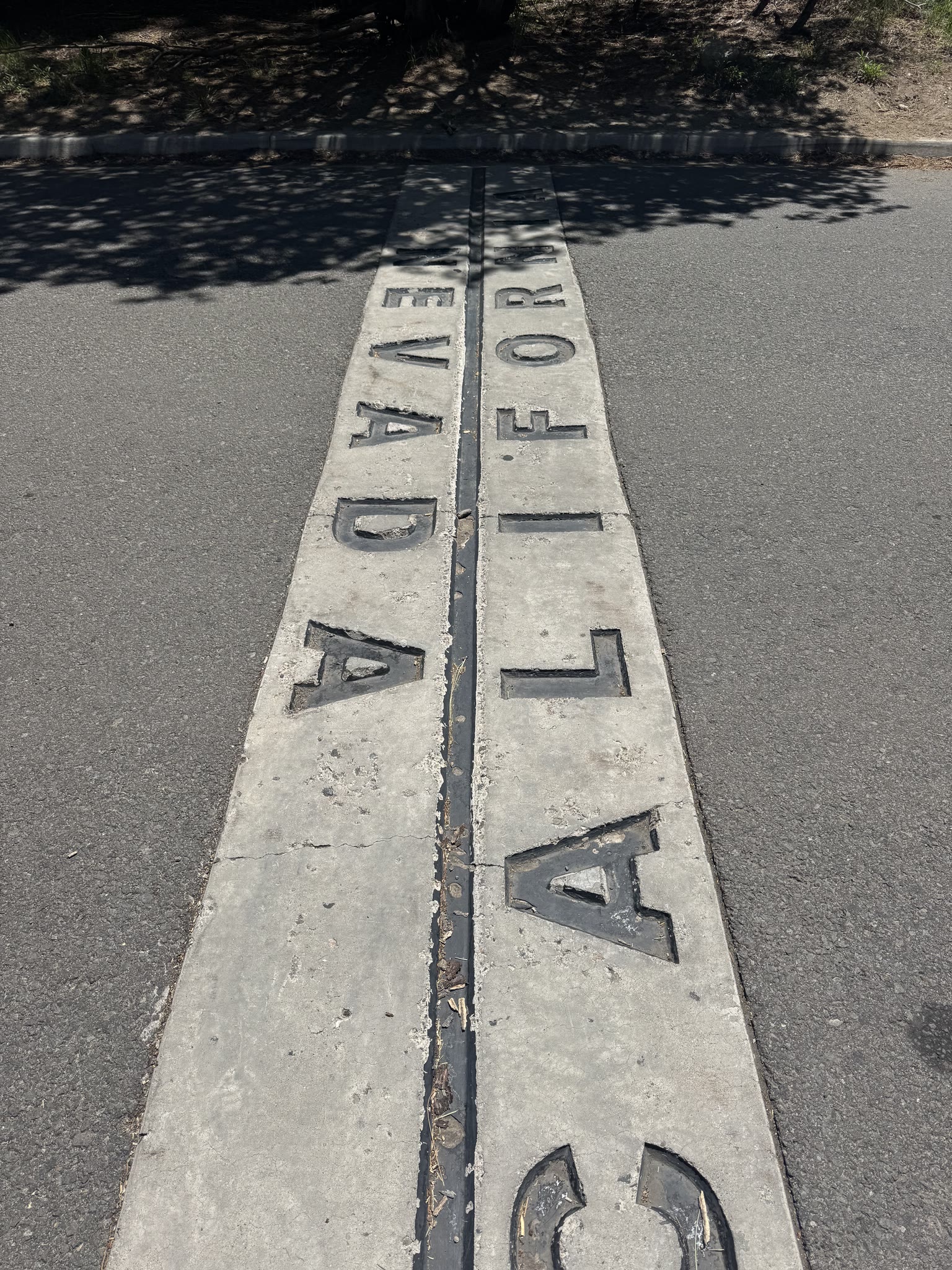 Concrete sidewalk inlay of the California / Nevada state line at South Lake Tahoe, "CALIFORNIA" on one side and "NEVADA" on the other